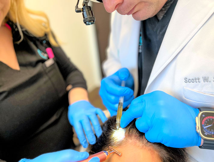 Dr. Scott Smith administering a PRP Hair Restoration treatment